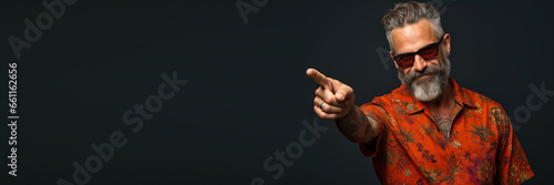 middle age man wearing casual clothes pointing with finger and hand looking to the camera against a grey background. Banner design with space for text