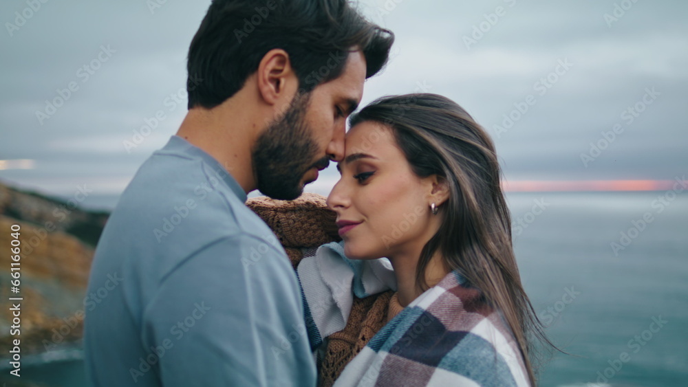 Couple love kissing coast close up. Happy pair standing hugging on sea shore. Couple love kissing coast close up. Happy pair standing hugging on sea shore.