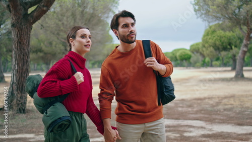 Couple going hike nature with backpacks. Happy family walking on autumn forest.