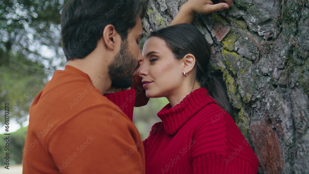 Fototapeta premium Portrait loving romantic couple near tree looking on each other with love.