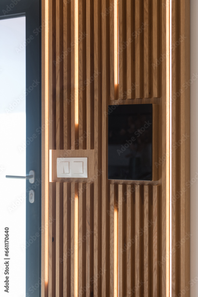 Wall with wooden brown slats in hallway of modern house Wall with wooden brown slats in hallway of modern house