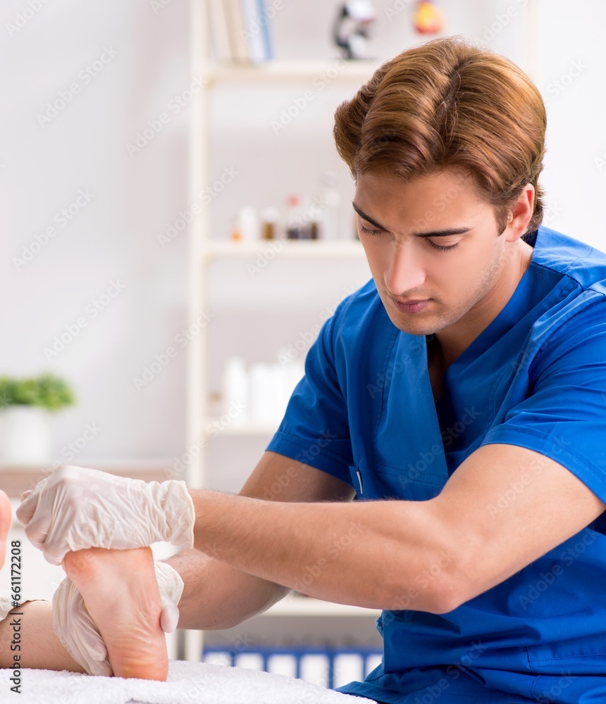 Podiatrist treating feet during procedure Podiatrist treating feet during procedure