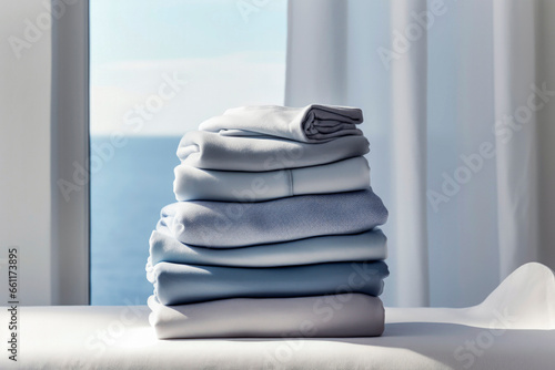Generative AI illustration of stack of folded sweaters placed on table against blurred window in daylight photo