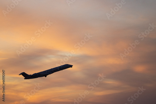 Airliner taking off against  sunset cloud