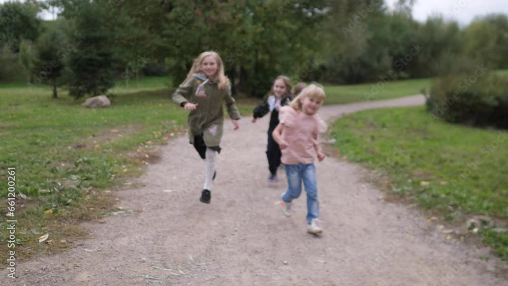 group of children - four little happy girls having fun in the summer park, running along the pedestrian path and laughing 4k slow motion group of children - four little happy girls having fun in the summer park, running along the pedestrian path and laughing 4k slow motion