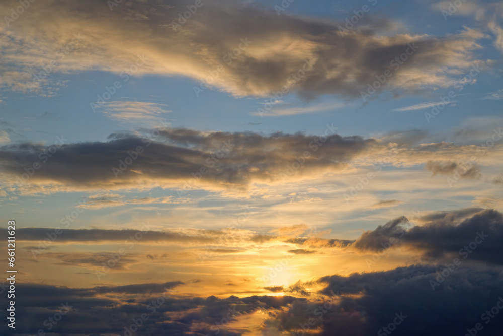 Summer evening sky in the picturesque clouds, lit by the rays of the setting sun. Summer evening sky in the picturesque clouds, lit by the rays of the setting sun.