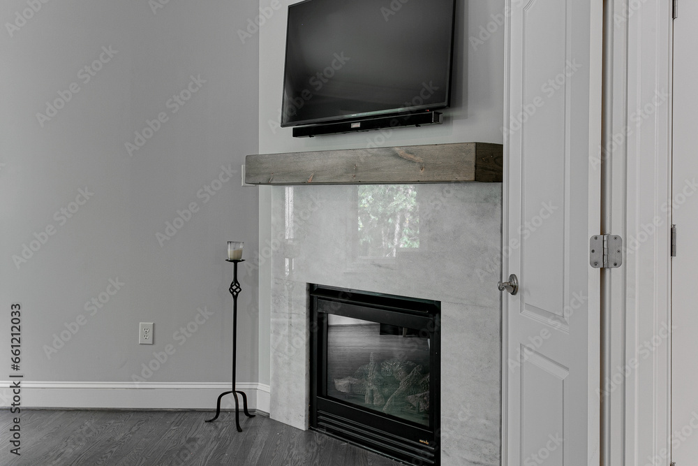 Luxury Modern Primary Bedroom Interior Electric Fireplace in Fall with Faux Wood Beam and Television Luxury Modern Primary Bedroom Interior Electric Fireplace in Fall with Faux Wood Beam and Television