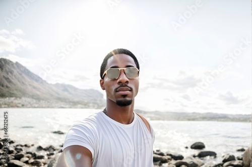 Selfies of an African American man taking selfies against a backdrop of water and mountains