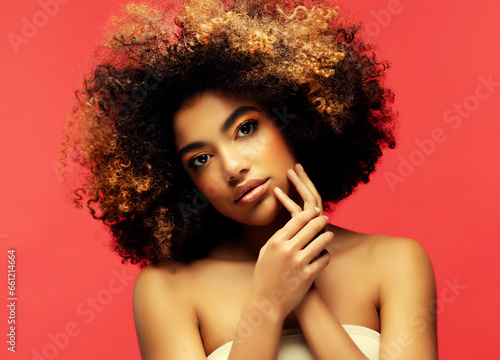 Young beautiful african american woman with afro hair.
