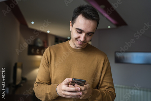 Portrait of young adult caucasian man use mobile phone for messages