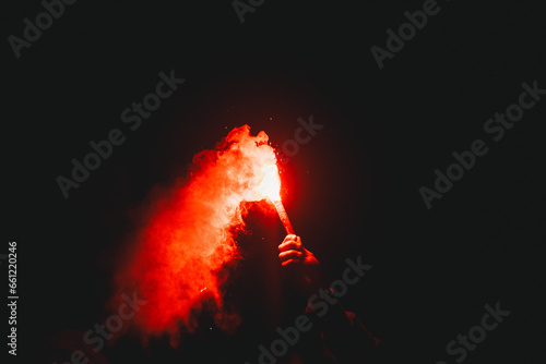 Football fan holding red flare during football match in Brazil.  It is a tradition to welcome Sport Club Internacional to games.