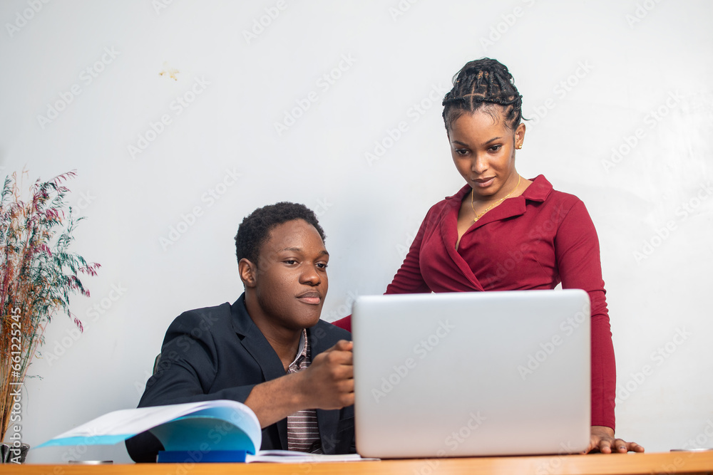 two african employees working together two african employees working together
