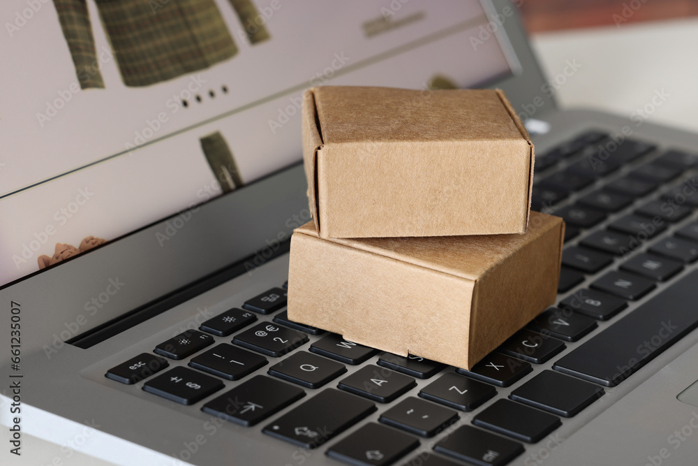 Mini boxes on laptop, closeup. Online store