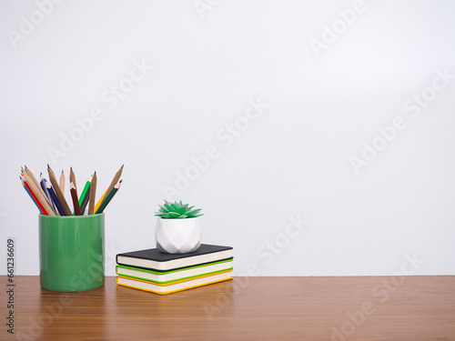 Office desk table, Student creative desktop with colorful stationery, hardcover book, potted cactus. Copy space for text, Back to school, Education concept