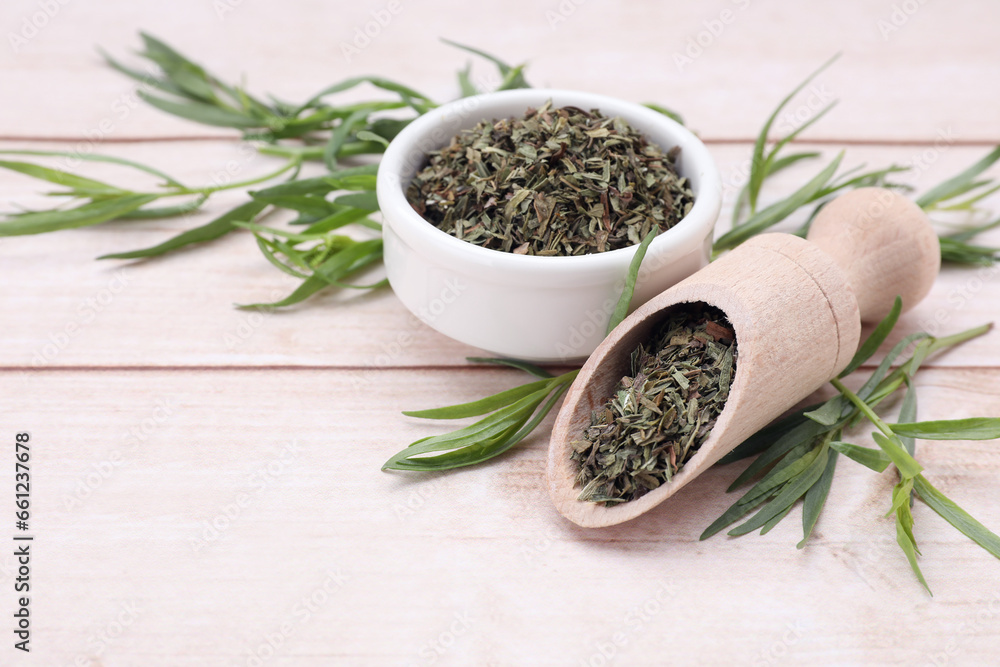 Dry and fresh tarragon on wooden table, space for text Dry and fresh tarragon on wooden table, space for text