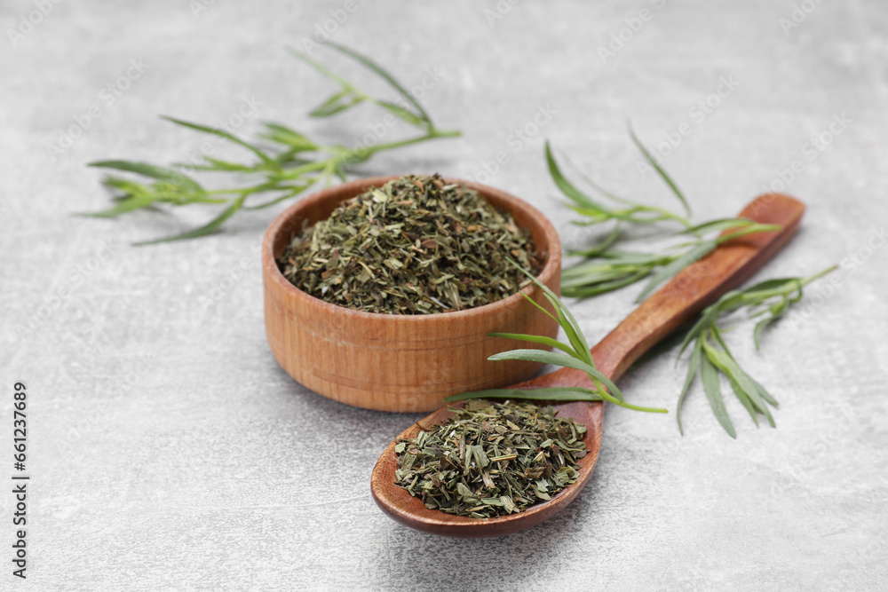Dry and fresh tarragon on light gray textured table Dry and fresh tarragon on light gray textured table