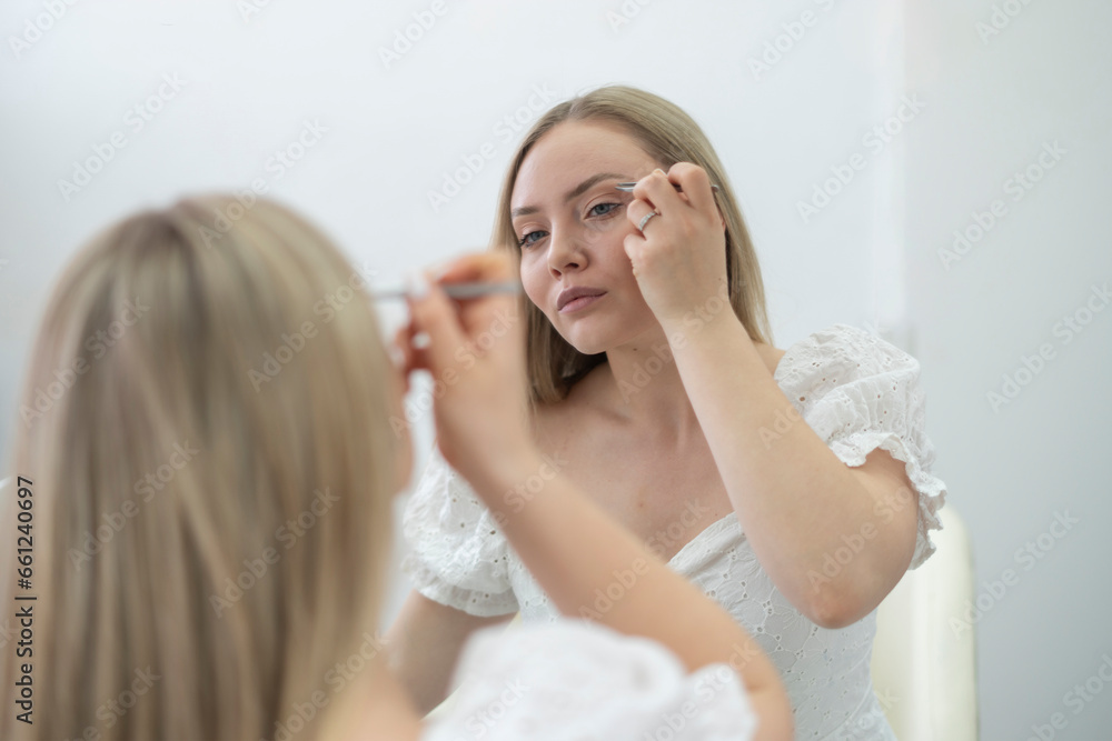 young girl doing makeup herself in the morning, daily routine young girl doing makeup herself in the morning, daily routine