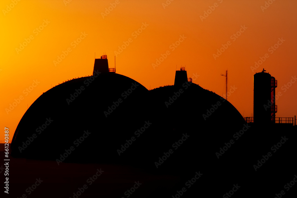 Silhouette of San Onofre nuclear power plant main reactors at sunset