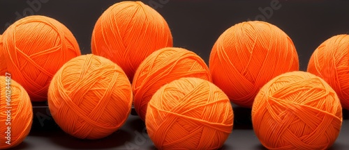 Orange balls of yarn on plain black background from Generative AI