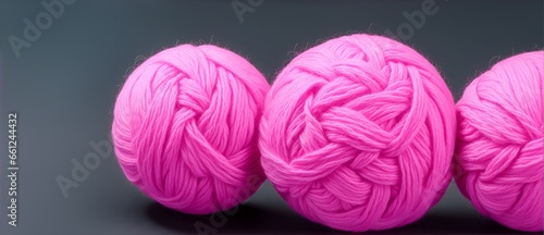 Pink balls of yarn on plain black background from Generative AI