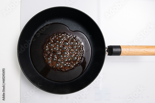 The soy sauce is boiling in the frying pan