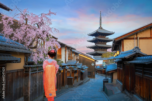 Young Japanese woman in traditional Kimono dress with Yasaka Pagoda at Hokanji temple in Kyoto, Japan