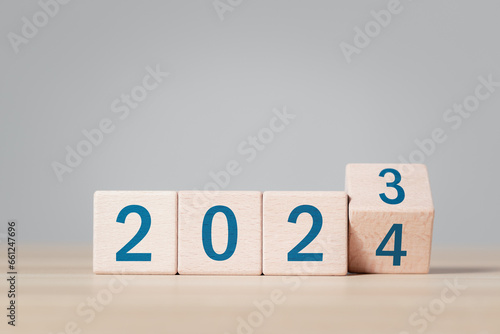 2024 growth business. wooden block with 2023 change to 2024, setup objective target business cost and budget planning for new year concept.