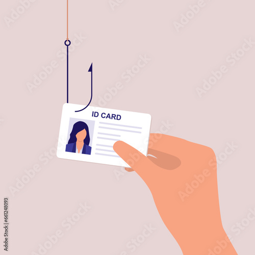 Concept Of Identity Theft. A Person’s Hand Holding An ID Card With Fishing Hook. Close-Up.