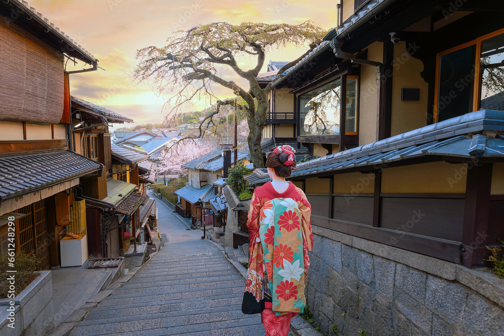 Young Japanese woman in a traditional Kimono dress at Nineizaka or Ninenzaka, an ancient pedestrian road in Kyoto, Japan 