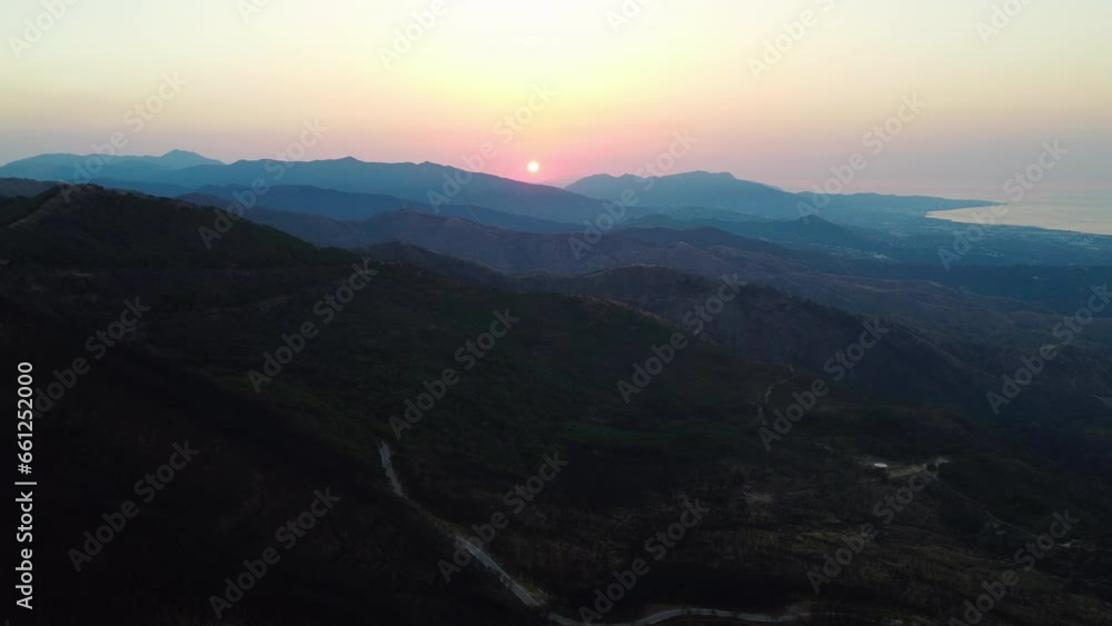 A drone high altitude aerial of a mountain road at sunset in Pico De Los Reales, Estepona, Spain. A drone high altitude aerial of a mountain road at sunset in Pico De Los Reales, Estepona, Spain.