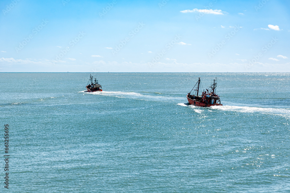 Two small Trawler fishing vessels, sailing in the Atlantic Ocean Two small Trawler fishing vessels, sailing in the Atlantic Ocean