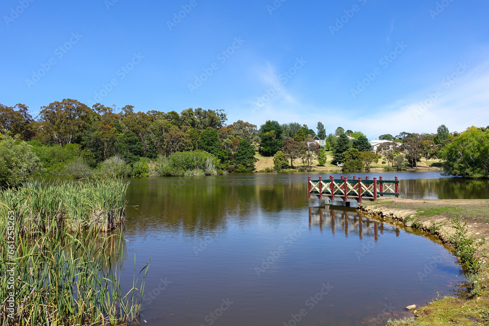 Beautiful scenery at Daylesford Lake with wooden viewing platform and  lush green trees in the background. The Natural attraction in Australia Victoria’s regional town is a popular sightseeing spot.