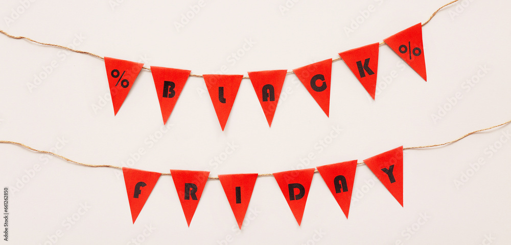 Garland with text BLACK FRIDAY on light background