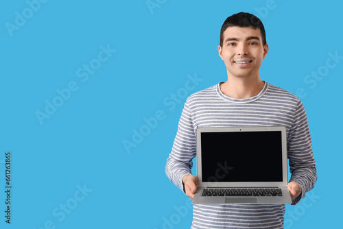 Young man with modern lapto...