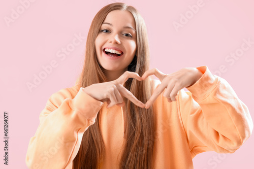 Young woman in hoodie makin...