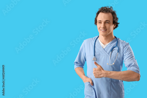 Young doctor showing thumb-...