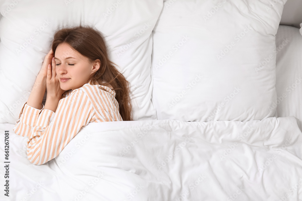 Morning of pretty young woman sleeping in soft bed, top view Morning of pretty young woman sleeping in soft bed, top view