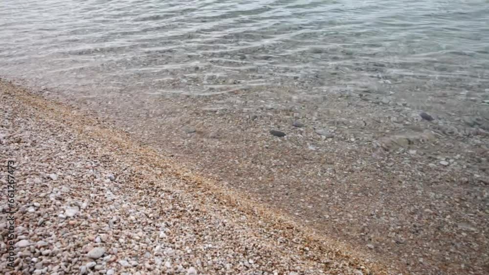 Baikal Lake. Video of sandy and pebble beach with pure transparent water. Natural background Baikal Lake. Video of sandy and pebble beach with pure transparent water. Natural background