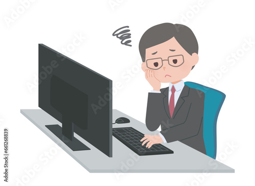 パソコンの前で悩むスーツの男性
