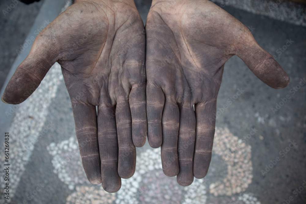 Fototapeta premium Dirty hands of a man working iron