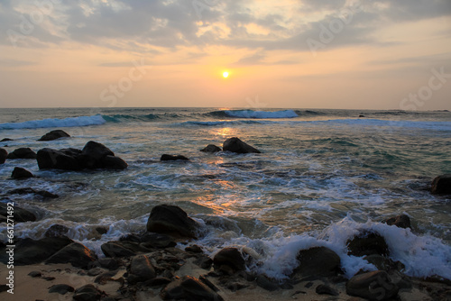 The sun setting into the sea at Delawella veach, Sri Lanka.