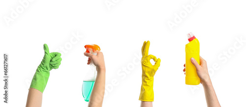 Women in rubber gloves with bottles of detergent on white background