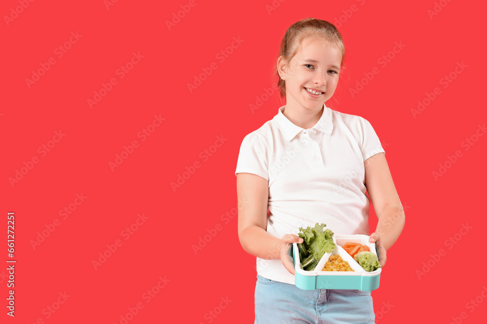Happy little girl with lunchbox on red background Happy little girl with lunchbox on red background