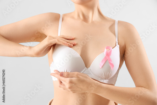 Young woman in bra with pin...