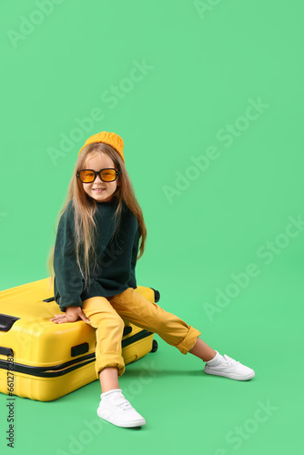 Cute little girl sitting on...