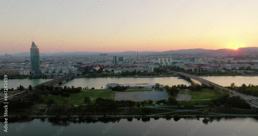 Donauinsel man made island in Danube river, cinematic view of Vienna skyline behind at sunset Donauinsel man made island in Danube river, cinematic view of Vienna skyline behind at sunset
