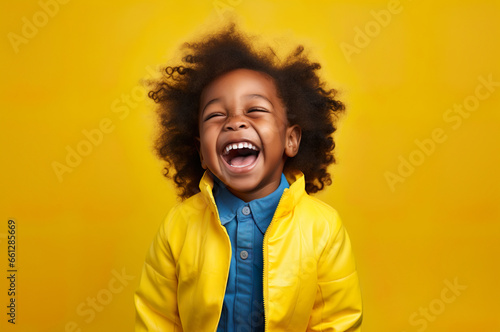 Photo of black kid on yellow background smiling © Kalim