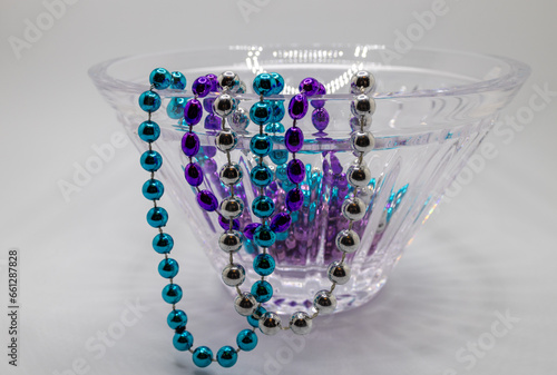 Fényképezés Close up view of a modern lead crystal glass bowl draped with colorful mardi gra