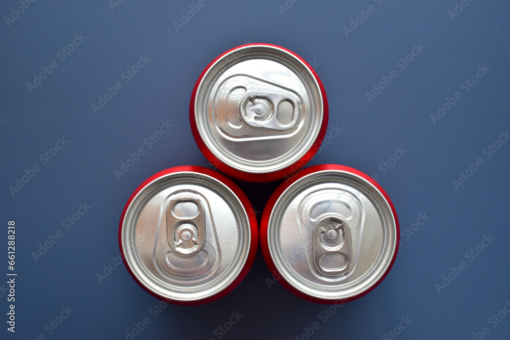 close up group of aluminium red cans soft drink put on blue texture background close up group of aluminium red cans soft drink put on blue texture background