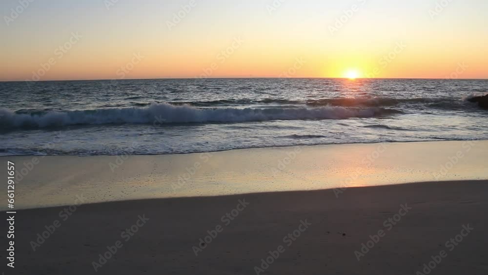 Calm ocean water waves captured in slow motion at golden hour. Handheld Calm ocean water waves captured in slow motion at golden hour. Handheld